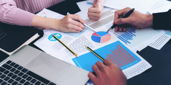 close up hand of  Business man busy at office desk  on  Notebook and documents  working  , business concept