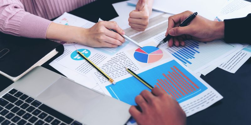 close up hand of  Business man busy at office desk  on  Notebook and documents  working  , business concept